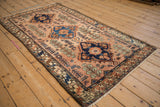 Angled view of a vintage Mehriban rug highlighting the glossy wool and color abrashes in its pile.