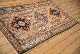 A collector's vintage Mehriban rug viewed at an angle to highlight its glossy wool and rich hues.