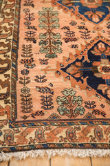 Detailed view of hand-knotted shrubs and blossoms on a dusty rose Mehriban rug.