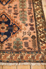Collector's vintage Mehriban rug corner showing the intricate border and dusty rose floral field.