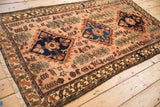 Angled view of a vintage Persian Mehriban rug, highlighting the lustrous wool pile and triple diamond design.