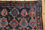 Intact original side cord selvage and even, dense pile on the corner of a vintage Persian rug.