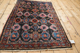 Full angled view of the vintage Persian Bibikabad rug's repeating artistic panels.