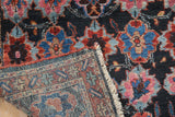 Folded corner of a collector Bibikabad rug, revealing the intricate hand-knotted weave and pile.