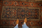 Overhead view of the antique Kurdish rug's geometric Herati pattern and low pile texture.