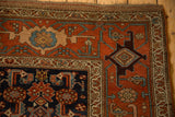 Corner detail of an antique Kurdish rug with terracotta Samovar and navy blue Herati motifs.