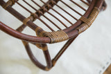 Intertwined dark and natural rattan weave detail on chair.