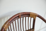 Textured detail of vintage rattan chair back, showing rich brown and golden tan tones.