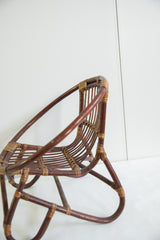 Vintage mid century rattan kid's chair with dark brown and natural rattan bindings.