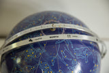 Vintage blue astrology globe showing zodiac signs Taurus, Gemini, and constellations.