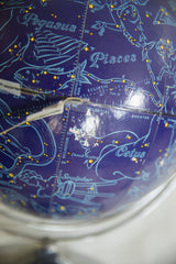 Vintage blue astrology globe showcasing Pegasus, Pisces, and Cetus constellations with surface wear.