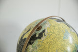 Vintage 1960s Rand McNally globe: northern continents, blue and dark oceans, distressed metal arc.