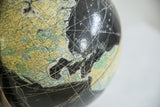 Worn vintage 1960s Rand McNally black globe, showing Atlantic grid and North American map.
