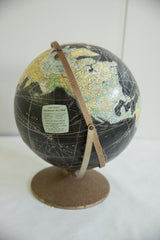 Worn bronze base and Rand McNally label of the black vintage globe.
