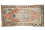 Distressed vintage Oushak rug runner, terracotta field, blue medallion, mint green details. 2'8