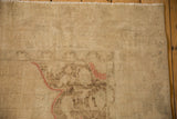 Distressed hand-knotted pile of a vintage Oushak rug with beige and dusty red motifs.