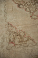 Distressed vintage Oushak rug runner with faded cinnabar medallion outline, floral fills, and visible foundation.
