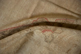 Reverse side of the vintage Oushak rug runner, revealing woven beige foundation and faint red numbers.