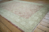 Distressed Sparta carpet corner with faded thousand flower motif and arabesque border.