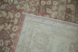 Distressed dusty rose floral pile and intricate hand-knotted foundation of a vintage Sparta rug.