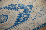 Low pile wear on the stepped sapphire blue medallion and sand-colored field of a Turkish Oushak.