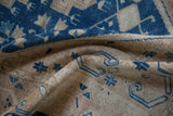 Distressed low-pile texture with sapphire blue geometric motifs on a vintage Oushak runner.
