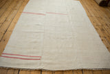 Angled perspective of a vintage hemp kilim highlighting its hand-seamed three-piece construction.