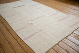 Vintage hemp kilim with seamed panels and horizontal stripes viewed from a low angle.