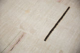 Close-up of a vintage hemp kilim showing its textured plain-weave and dark brown accent stripe.