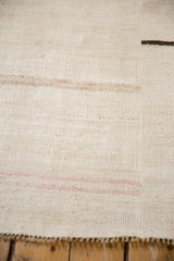 Close-up of a vintage Turkish hemp kilim showing the plain-weave texture and vertical seam.