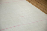 Subtle hourglass motif stitched into the ivory plain-weave of a vintage hemp kilim.