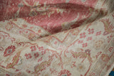 Distressed pile texture in pale raspberry and ivory floral design.