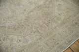 Distressed vintage Turkish Tabriz carpet edge, showing machine-bound side, fringe, and faded floral pattern.