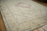 Distressed vintage Turkish Tabriz border with faded Herati pattern motifs.