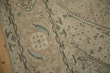 Distressed beige Turkish Tabriz rug with worn Herati field and dusty blue motifs.