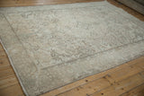 Distressed vintage Turkish Tabriz carpet, close-up of worn pile, exposed foundation, and machine-bound edge.
