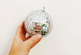 Medium disco ball ornament covered in small, square mirrored tiles.