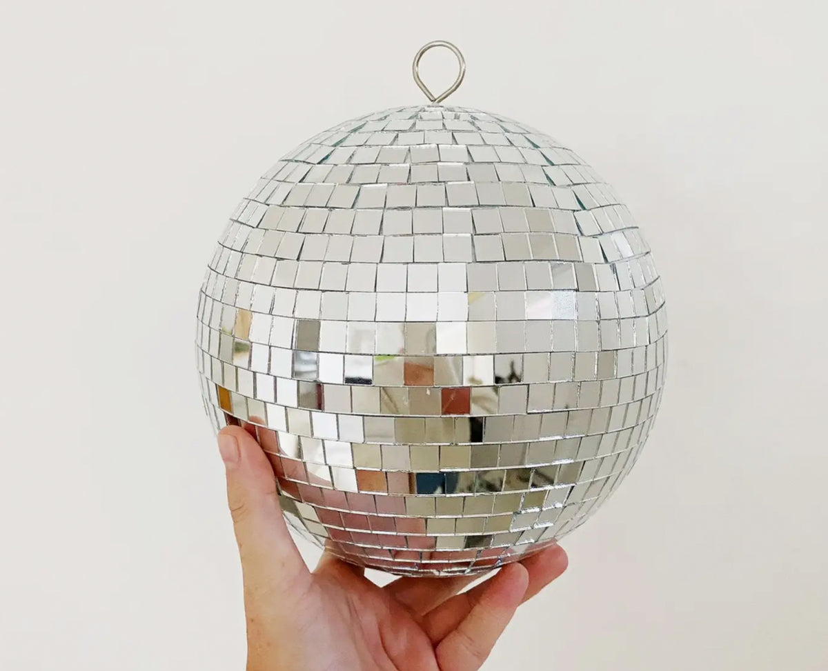 Large disco ball with a reflective mosaic of square mirror tiles and a metal hanging loop.