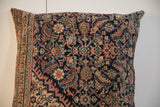Close-up of vintage Persian Fereghan pillow with intricate navy, ivory, and terracotta pattern.