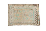 Vintage distressed Oushak rug with a tree of life design in mint green and charcoal on a cream ground.