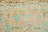 Close-up of the vintage Oushak rug's texture, with low pile and exposed knot heads.