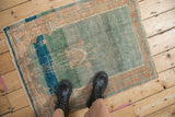 Soft wool weave showing prominent color abrashes in jade green, sapphire blue, and sandalwood.