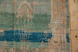 Hand-knotted wool pile showing abrashes of jade green, sapphire blue, and sandalwood tones.