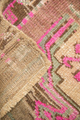 Distressed Kars rug detail: textured pile, reverse, and selvage showing magenta, camel, green geometrics.