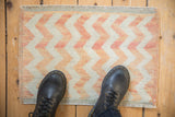 Softly distressed Oushak rug mat features lightning chevron stripes with abrashes.