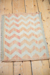 Close-up of distressed Oushak rug, textured lightning chevron stripes, ivory and pale orange.