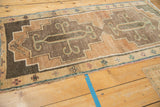 Close-up of Vintage Kars rug runner: stepped contour, charcoal, coffee field, dusty teal, pink border.