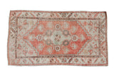 Distressed Oushak runner with a pale red finned medallion, seafoam green, and serpent border. 2'8