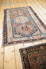 Vintage Anatolian rug showing terracotta gul, geometric motifs, navy border, and faint foundation.