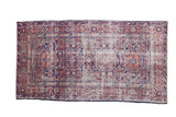 Vintage Anatolian runner with geometric gul medallions in cherry red, cobalt blue, and silver.